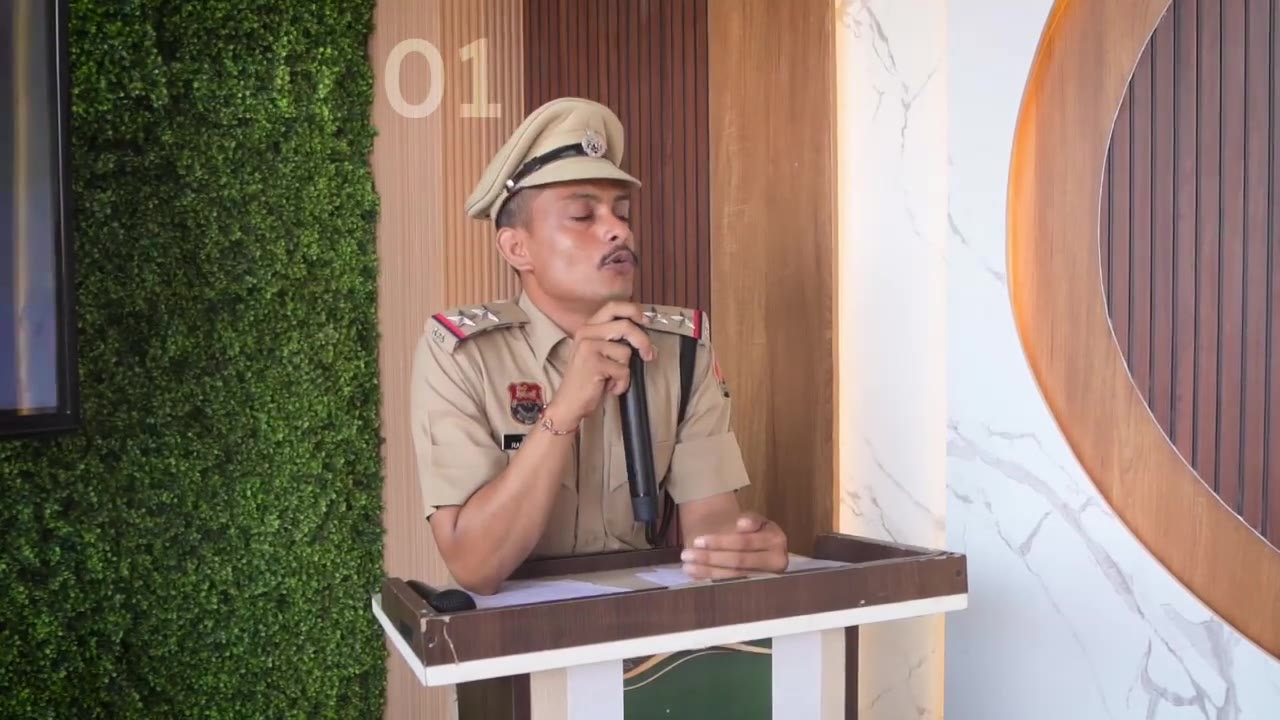 A speaker in uniform holding a microphone at a lectern
